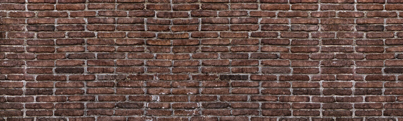 Old shabby red brick wall wide grunge texture. Aged rough brickwork panoramic background