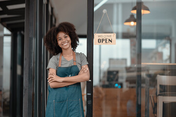 Small business owner standing at  the cafe entrance, Young African American Woman Cafe Owner. 