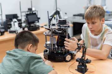 Group Kid teen child enjoy Machine Learning Robot arm is Moving Under coding Control robot at stem technology class, stem education for digital automation learn for use artificial intelligence ai