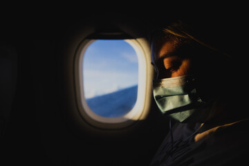 view from an airplane window and woman with mask