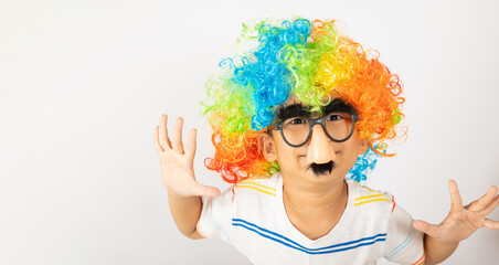 April Fool's Day. Two brothers funny kid boy clown wears curly wig colorful big nos and glasses and has mustache playing fool isolated on white background with copy space, Happy child festive decor
