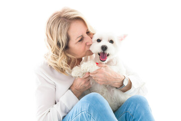 Obraz premium Cheerful retired senior woman with dog and enjoying time with pet on studio white