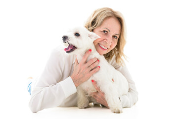 Cheerful retired senior woman with dog and enjoying time with pet on studio white