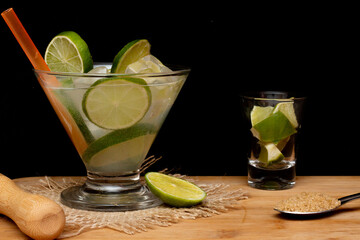 brazilian drink (caipirinha) with sugar and ingredients around