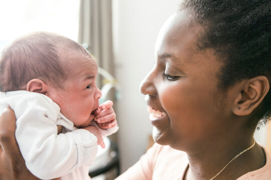A Portrait of a beautiful black mother, with her nursing baby