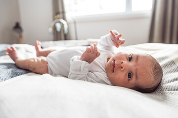 Obraz na płótnie Canvas black newborn baby lay on bed at home