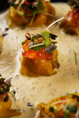 dumplings with caviar in a creamy sauce