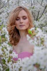 Portrait of a girl in a blooming garden. Blooming trees, traditional asian, travel, seasonal april background.