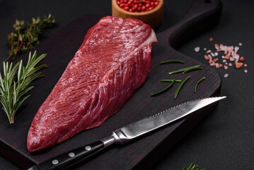 Beautiful fresh piece of raw beef on a wooden cutting board