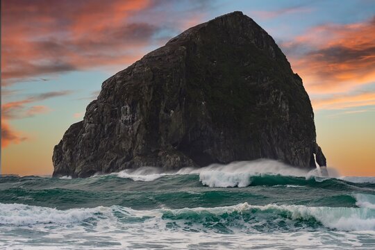Heavy surf crashing on the Haystack rock and the beach at Pacific City on the Oregon coast