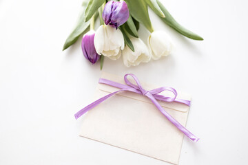 greeting card mockup. bouquet of purple tulips isolated on a white background. space for text. invitation. congratulation.