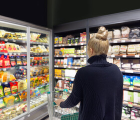 supermarket shopping,Woman choosing a dairy products at supermarket.