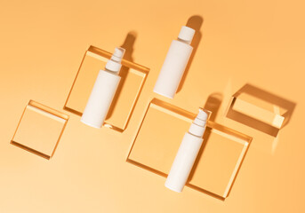 White cosmetic tubes mockup on glass pedestal. Bottles layout , packaging product. Cream, gel, tonic, cleanser, lotion and other professional cosmetics product presentation. Studio photography.