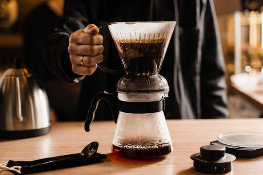 Pouring coffee in pot from clever dripper with pour over filter in cafe. Alternative method of brewing coffee in clever dripper at home.