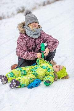 The girls are playing in the snowy forest. It's a cold winter, snow and ice.