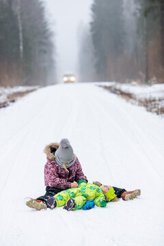 The girls are playing in the snowy forest. It's a cold winter, snow and ice.