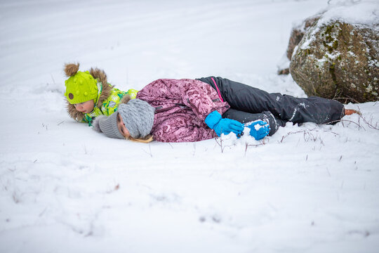 The girls are playing in the snowy forest. It's a cold winter, snow and ice.