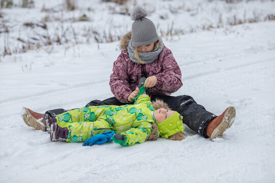 The girls are playing in the snowy forest. It's a cold winter, snow and ice.