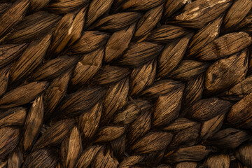 detail of a dark brown basket woven from water hyacinths