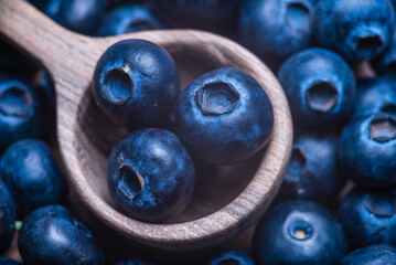 wood spoon Water drops on ripe sweet blueberry. Fresh blueberries background with copy space for your text. Vegan and vegetarian concept.  Delicious Fresh Close up.