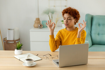 No stress keep calm. Mindful african businesswoman practices breathing exercises at home office....