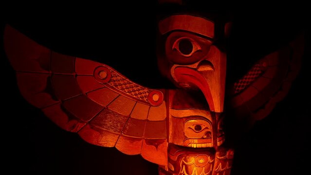 Traditional Totem Pole In Fire Light Outdoors
