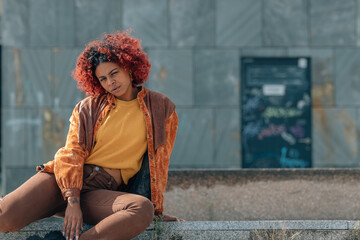 girl on the street sitting looking at the camera