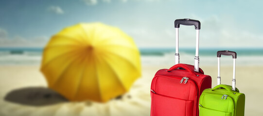 couple of suitcases or luggage with beach in the background