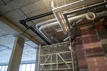New pipe installation, mounted under the ceiling near plasterboard wall.