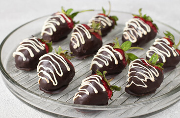 Delicious chocolate covered strawberries on gray background