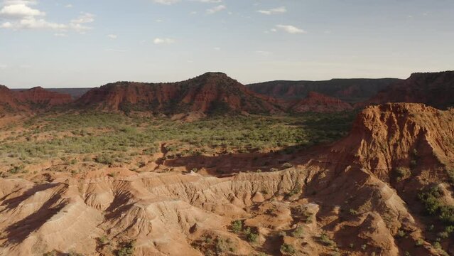 Revealing shot of valley floor Texas landscape during sunset at Caprock Canyons State Park - 4K Drone