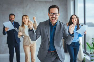 Excited happy multiracial businesspeople have fun engaged in activity in office together, overjoyed diverse colleagues dance celebrate successful business project, Friday celebration concept