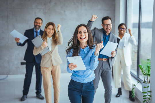Portrait of overjoyed young diverse employees workers show thumb up recommend good quality company service. Smiling multiethnic colleagues celebrate shared business success or victory in office