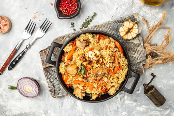 Uzbek pilaf in cast-iron pan. banner, menu, recipe place for text, top view