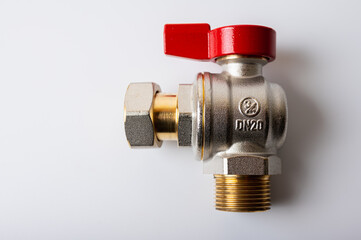 close up view, brass metal water faucet with red valve, different angle isolated on light background, plumbing connection