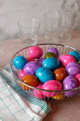 Colorful dyed Easter eggs in a chrome basket