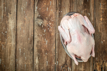 Raw free range duck with spices ready to cook on a wooden background, Culinary cooking. banner,...