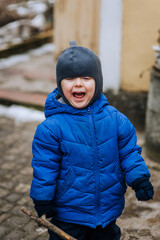 Naughty, screaming boy, child crying while standing outdoors. Photography, emotions.