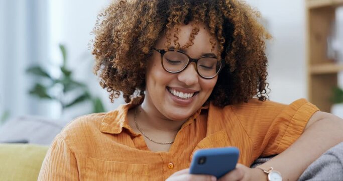 Woman laughing on a phone and sofa for funny internet meme, social media post or texting on mobile app. Young happy person on couch or living room typing on a cellphone, smartphone or web chat