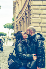 Fototapeta na wymiar Happy Tourists couple traveling at Rome, Italy, Hugging on the streets of , Rome, Italy Concept of Italian travel. 