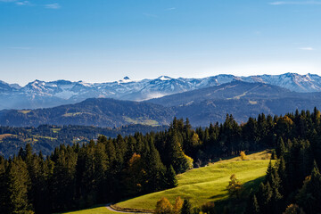 Beautiful alpine landscape with green meadows, alpine cottages and mountain peaks, Austria