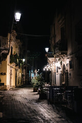 Fototapeta na wymiar Syracuse is a historic city on the Italian island of Sicily - an old street in the night - off season - night photo - calm street - lights on the streets 