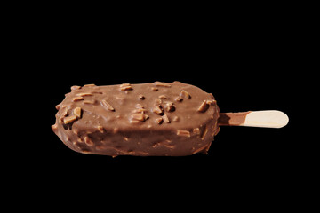 Chocolate ice cream on a stick black background