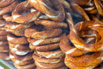 Freshly baked turkish simits, bagels sprinkled with sesame seeds behind glass showcase. Traditional...