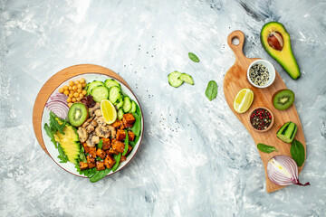Fototapeta na wymiar Vegan tofu poke bowl with avocado, chickpeas, cucumber and mushrooms, Healthy asian diet vegan vegetarian salad food. banner, menu, recipe place for text, top view