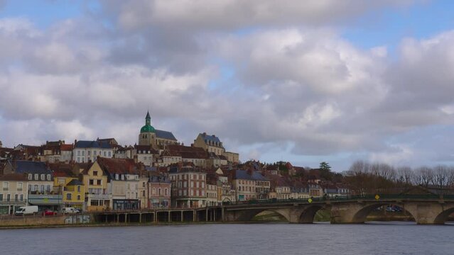 View of a beautiful street and houses with old traditional French houses in the center of Joigny with clouds in the background. Legacy of French history. Historic hotels, colorful houses in France