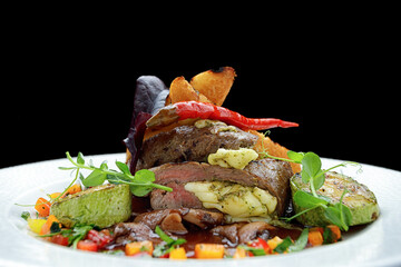 Baked meat stuffed with cheese, with herbs and vegetables