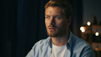 Serious man watching pc at home closeup. Focused freelancer reading computer