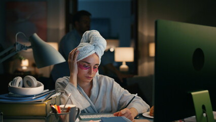 Busy worker writing notes at night flat closeup. Tired girl trying concentrate