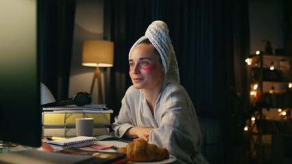 Fototapeta na wymiar Closeup freelancer working computer late at night. Smart bathrobe woman smiling